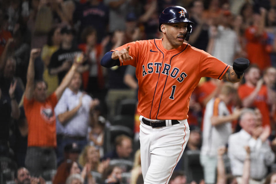 Houston Astros' Carlos Correa reacts after scoring on Aledmys Diaz's two-run single during the fourth inning of a baseball game against the Los Angeles Angels, Friday, Sept. 10, 2021, in Houston. (AP Photo/Eric Christian Smith)