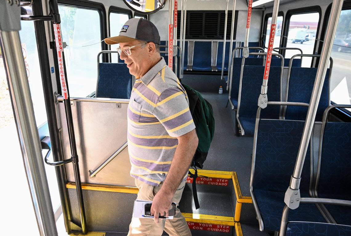 Fresno Bee columnist Marek Warszawski gets off a Fresno FAX bus before getting on another while spending the day riding through town on Tuesday, Aug. 15, 2023.