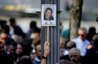 <p>A woman holds up a picture of a victim of the 9/11 terrorist attacks during a ceremony at ground zero in New York, Monday, Sept. 11, 2017. Holding photos and reading names of loved ones lost 16 years ago, 9/11 victims’ relatives marked the anniversary of the attacks at ground zero with a solemn and personal ceremony. (Photo: Seth Wenig/AP) </p>