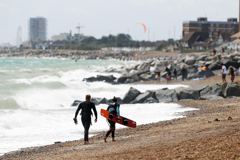 Kitesurfers make the most of the strong wind and choppy waves on Lancing Beach, Sussex, as they enjoy kitesurfing on Monday 27 July.