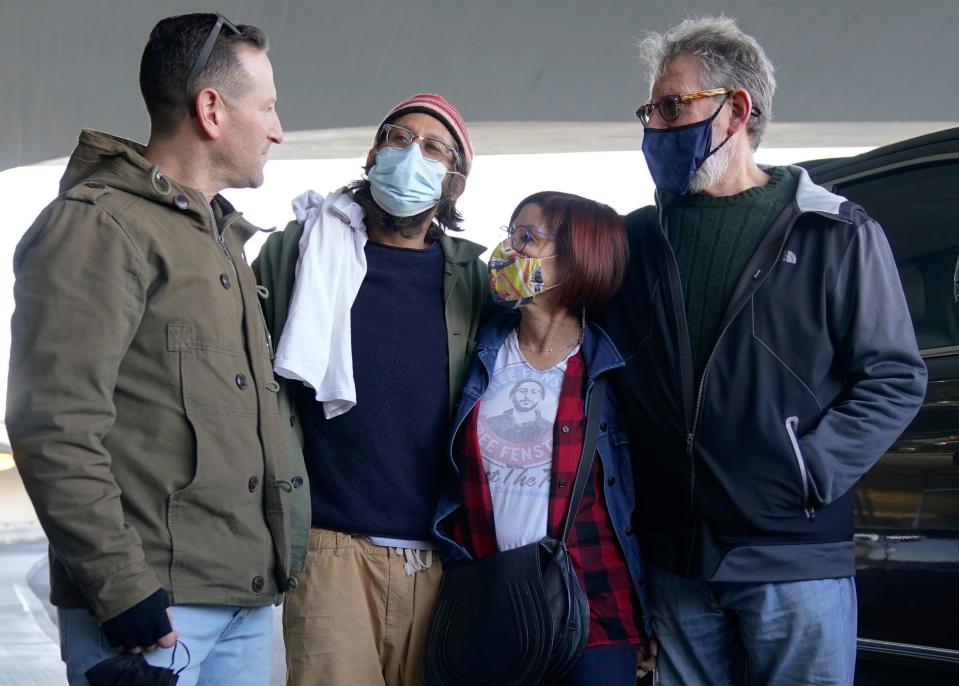 American journalist Danny Fenster, second from left, is greeted by his brother, Bryan Fenster, left, his mother, Rose Fenster, second from right, and his father, Buddy Fenster, after arriving at John F. Kennedy Airport in New York, Tuesday, Nov. 16, 2021. Fenster was sentenced last week to 11 years of hard labor, but he was handed over Monday to former U.S. diplomat Bill Richardson, who helped negotiate the release.