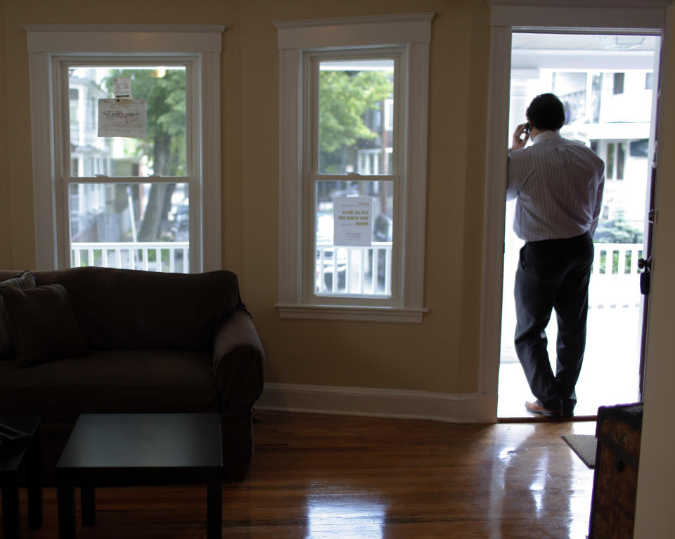 Realtor Steve Bremis talks on the phone during an open house at a condominium unit in Somerville, Massachusetts. (Credit: Brian Snyder, REUTERS)   