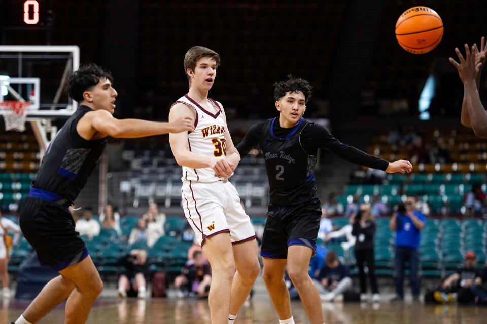Windsor's John Backhaus and Mesa Ridge's Bryce Riehl (2) look for the ball during a class 5A state championship game against Mesa Ridge at the Denver Coliseum on Saturday.