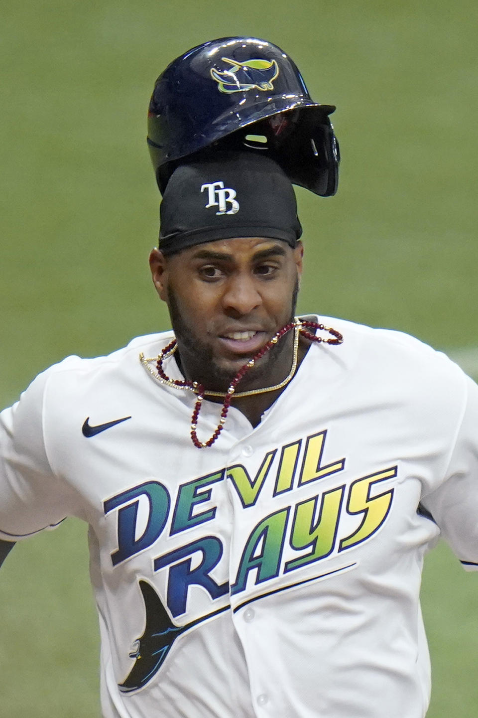 Tampa Bay Rays' Yandy Diaz loses his helmet as he scores on an RBI single by Ji-Man Choi off Philadelphia Phillies starting pitcher Zack Wheeler during the sixth inning of a baseball game Saturday, May 29, 2021, in St. Petersburg, Fla. (AP Photo/Chris O'Meara)