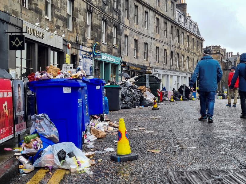 Waste is overflowing from bins on a street amid a strike by waste services workers in Edinburgh