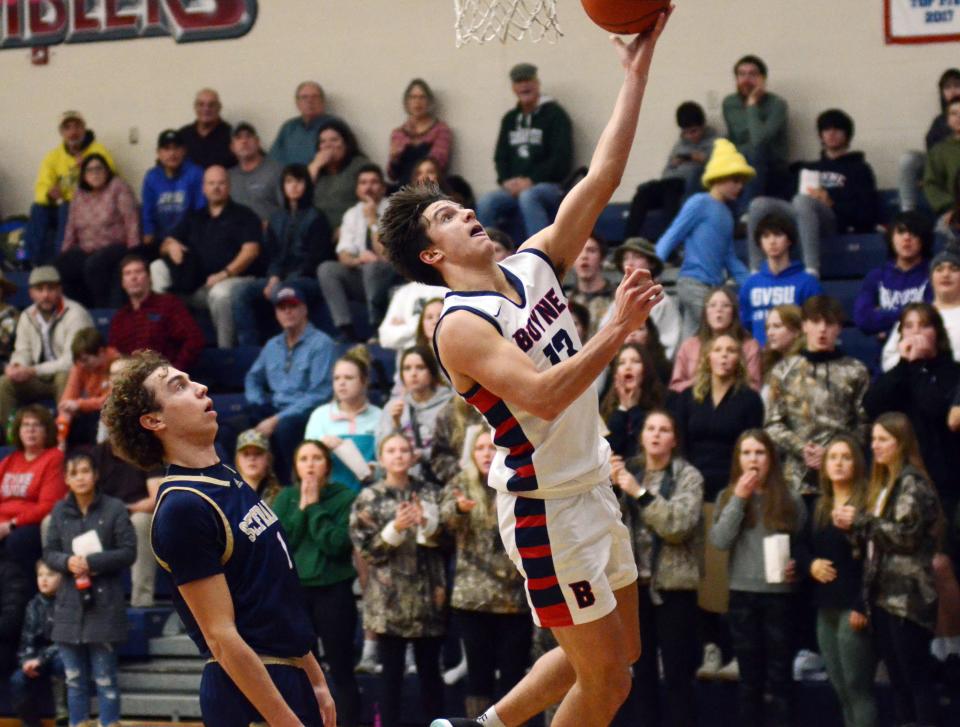 Boyne City senior Alex Calcaterra drives and scores in front of TC St. Francis' Wyatt Nausadis in the second half of Tuesday's game.