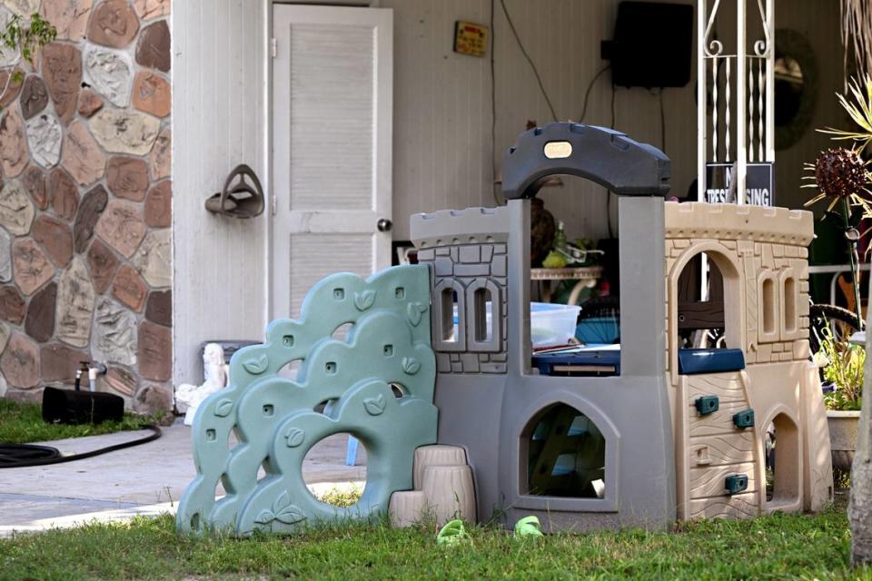 Play equipment and a small pair of green crocs sit outside the home of Nicholas Bassler Jr. and Sierra Campany of Bradenton. The couple were arrested on sexual battery and child porn charges, the Manatee County Sheriff’s Office said.