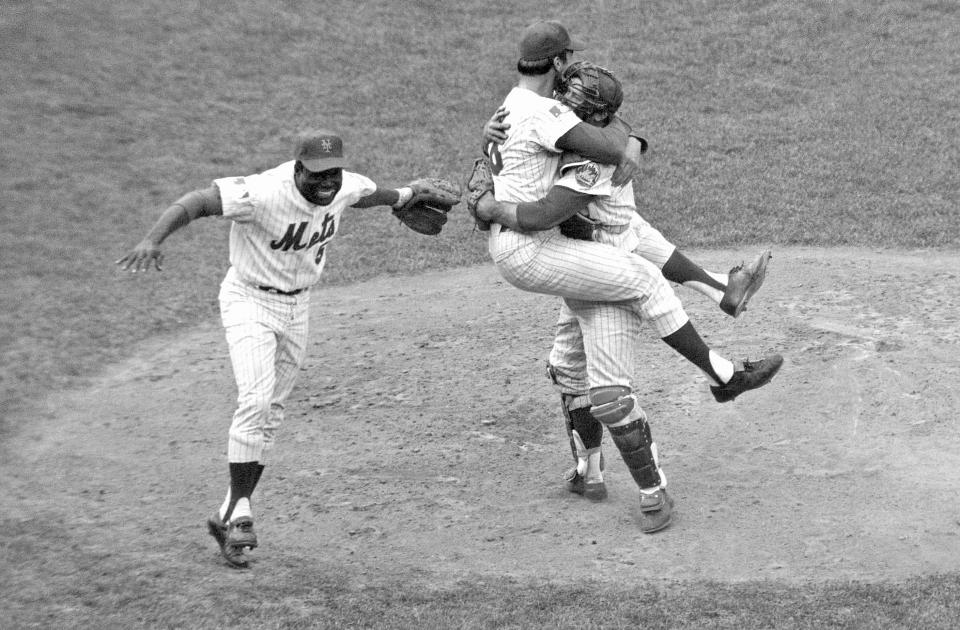 FILE - In this Oct. 16, 1969 file photo, New York Mets catcher Jerry Grote, right, embraces pitcher Jerry Koosman as Ed Charles, left, joins the celebration after the Mets defeated the Baltimore Orioles in the Game 5 to win the baseball World Series at New York's Shea Stadium. Grote, the catcher who helped transform the New York Mets from a perennial loser into the 1969 World Series champion, died Sunday, April 7, 2024. (AP Photo, File)