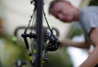 A Tinkoff-Saxo mechanic checks a bike before a training session in Utrecht, Netherlands, July 3, 2015. REUTERS/Eric Gaillard