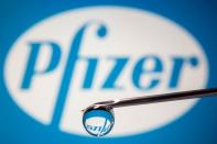 FILE PHOTO: Pfizer's logo is reflected in a drop on a syringe needle in this illustration
