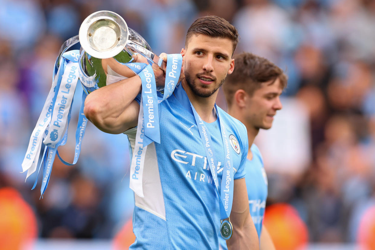 MANCHESTER, ENGLAND - MAY 22: Ruben Dias of Manchester City with the Premier League Trophy during the Premier League match between Manchester City and Aston Villa at Etihad Stadium on May 22, 2022 in Manchester, United Kingdom. (Photo by Robbie Jay Barratt - AMA/Getty Images)