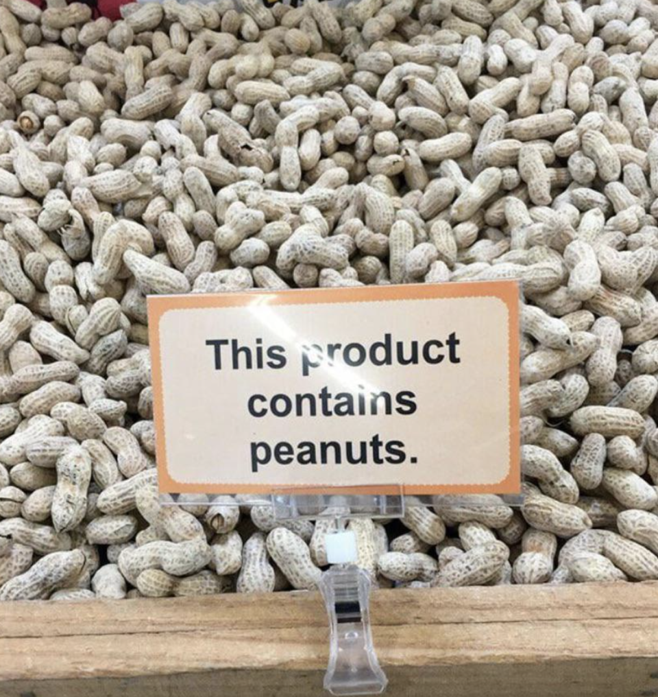 Sign on peanuts display reads "This product contains peanuts."