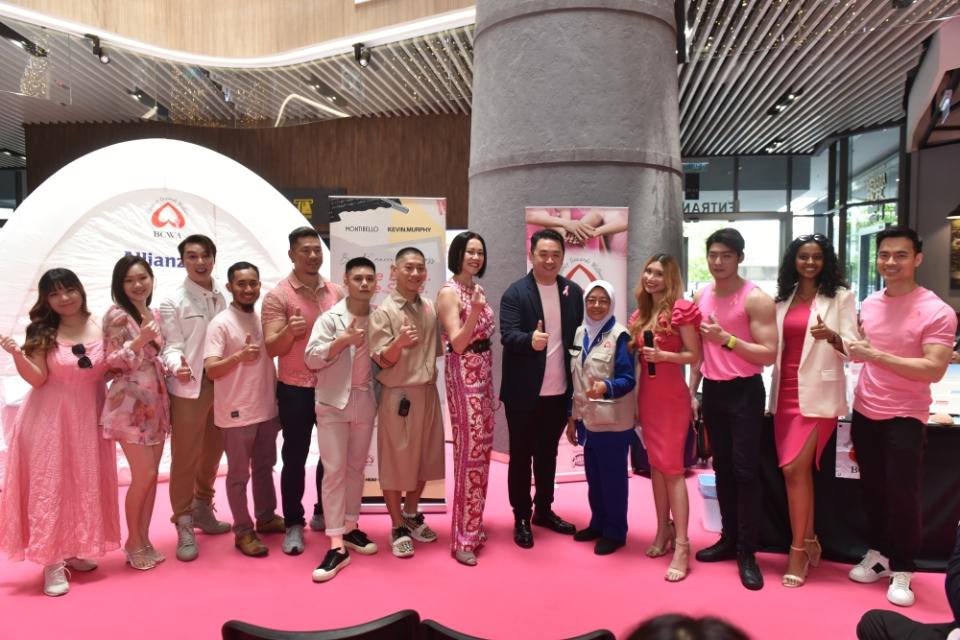 Kow (in jacket) with BCWA representative Salimah Saleh (fifth from right), Phoebe (fourth from right) and celebrity guests who were all dressed in pink.  — Picture courtesy of R Beaute