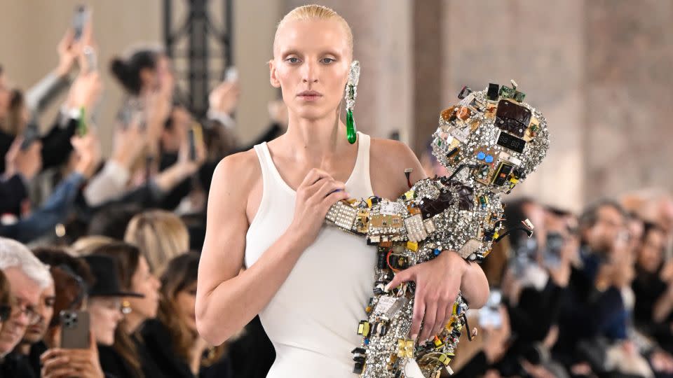 A model takes to the runway with Schiaparell's "robot baby". - Giovanni Giannoni/WWD/Getty Images