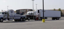 <p>A tractor-trailer is pulled from the scene where San Antonio police and other agencies investigate the scene where eight people were found dead in the trailer loaded with at least 30 others outside a Walmart store in stifling summer heat in what police are calling a horrific human trafficking case, Sunday, July 23, 2017, in San Antonio. (AP Photo/Eric Gay) </p>