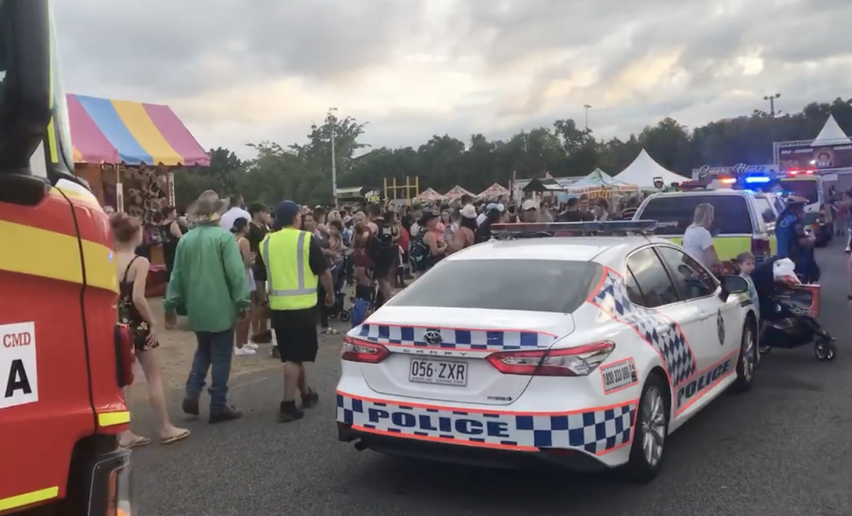 Photo shows crowd at the Cairns Showfest and a line of emergency vehicles. 