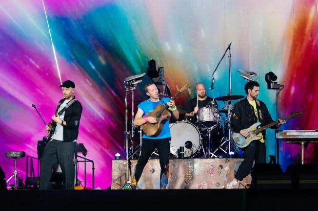 Will Champion of Coldplay performs on stage at Wembley Stadium