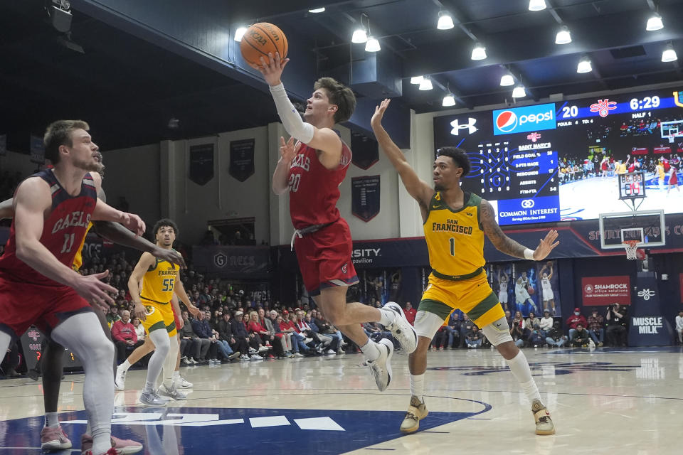 Saint Mary's guard Aidan Mahaney (20) shoots in front of San Francisco guard Malik Thomas (1) during the first half of an NCAA college basketball game in Moraga, Calif., Tuesday, Feb. 20, 2024. (AP Photo/Jeff Chiu)