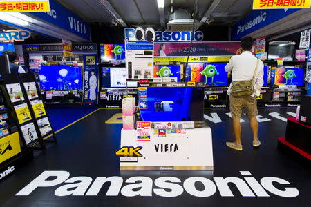 A man looks at television sets by Japanese firm Panasonic at an electronics retailer in Tokyo June 10, 2015. REUTERS/Thomas Peter