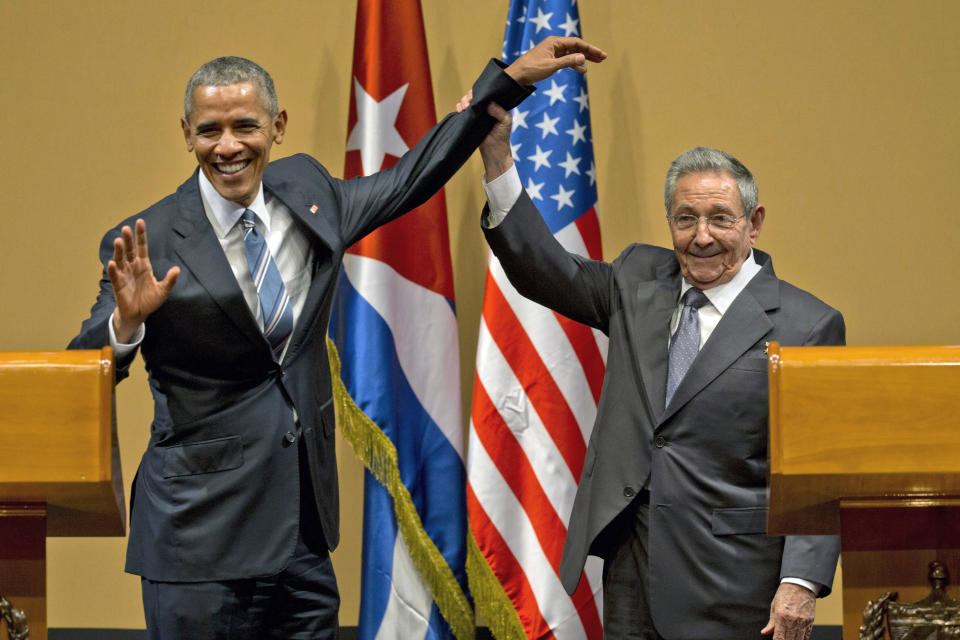 FILE - In this March 21, 2016, file photo, Cuban President Raul Castro, right, lifts up the arm of President Barack Obama at the conclusion of their joint news conference at the Palace of the Revolution in Havana, Cuba. Obama's handling of the Syrian civil war was widely perceived as a major foreign policy failure. That stood alongside substantial foreign policy wins, including the Iran nuclear deal, which infuriated traditional U.S. allies Israel and Saudi Arabia, and normalization of relations with Cuba, both of which Trump made a priority to rip apart. (AP Photo/Ramon Espinosa, File)