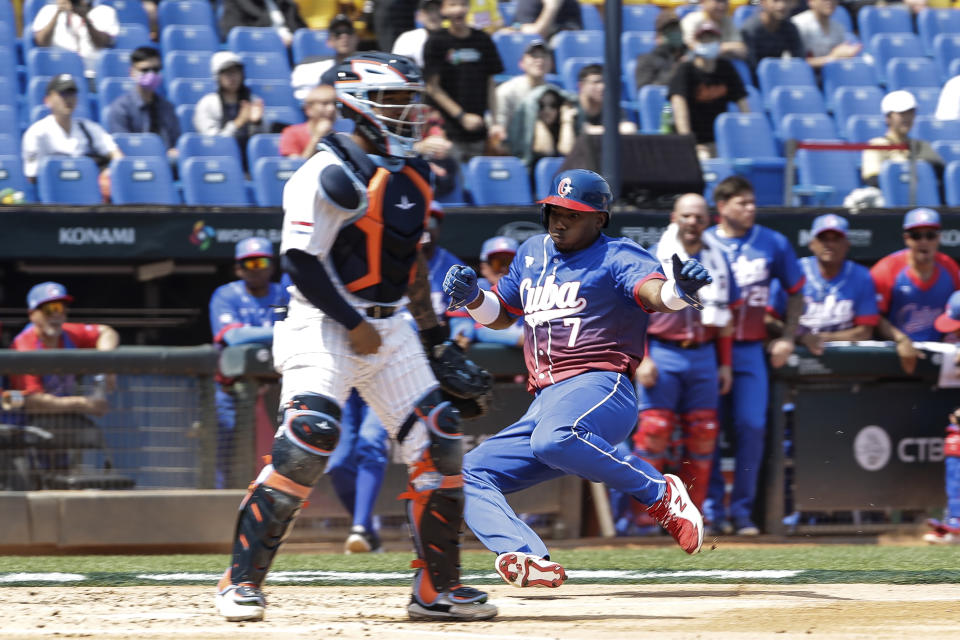 Cuba's Yoelquis Guibert slides to the home base during the Pool A game against Netherlands in the World Baseball Classic at Taichung Intercontinental Baseball Stadium in Taichung, Taiwan on Wednesday, March 8, 2023. (AP Photo/I-Hwa Cheng)