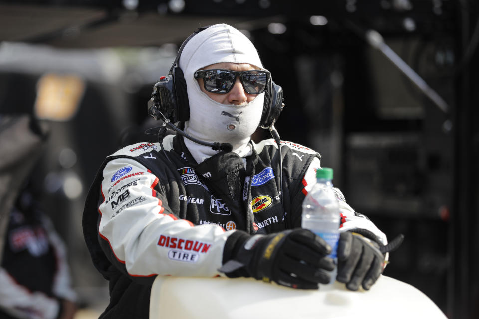 A crew member for race driver Brad Keselowski stands behind a cooling machine as temperatures approached 90 during the NASCAR Cup Series auto race at Indianapolis Motor Speedway in Indianapolis, Sunday, July 5, 2020. (AP Photo/Darron Cummings)