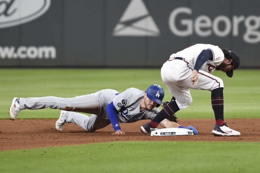 Atlanta, GA - October 16: Los Angeles Dodgers' Trea Turner, left, slides into second ahead of the tag.