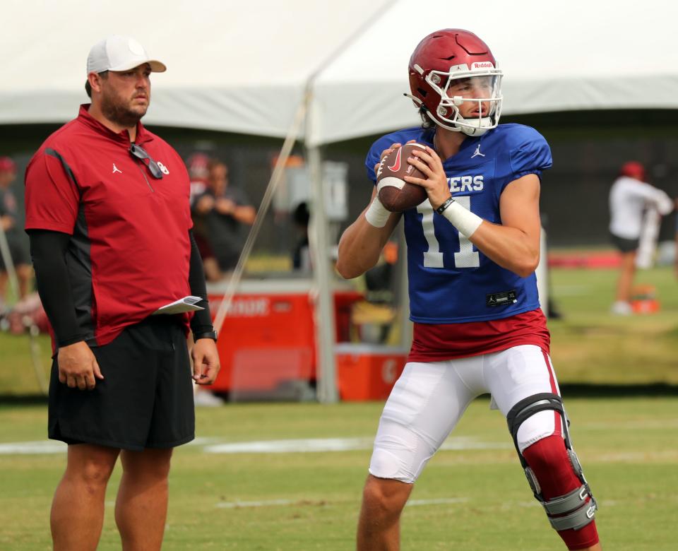 OU quarterback Davis Beville (11) goes through drills in front of offensive coordinator Jeff Lebby in Norman on Aug. 16.