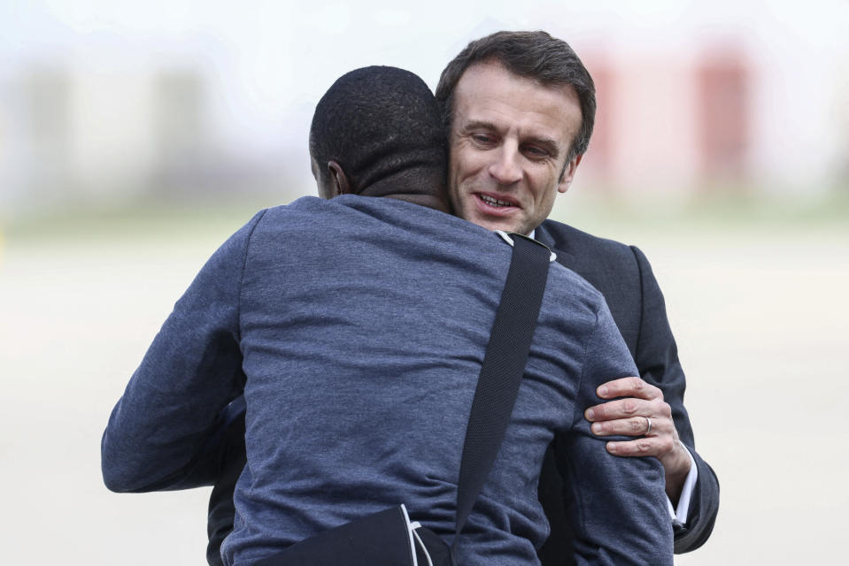 French President Emmanuel Macron, right, greets freed French hostage journalist Olivier Dubois, who was held hostage in Mali for nearly two years, upon his arrival at the military airport in Villacoublay, near Paris, Tuesday, March 21, 2023. (Yves Herman, Pool via AP)