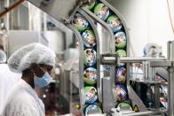 Tubs of Ben & Jerry's ice-creams are seen as a labourer works at their factory in Be'er Tuvia, Israel