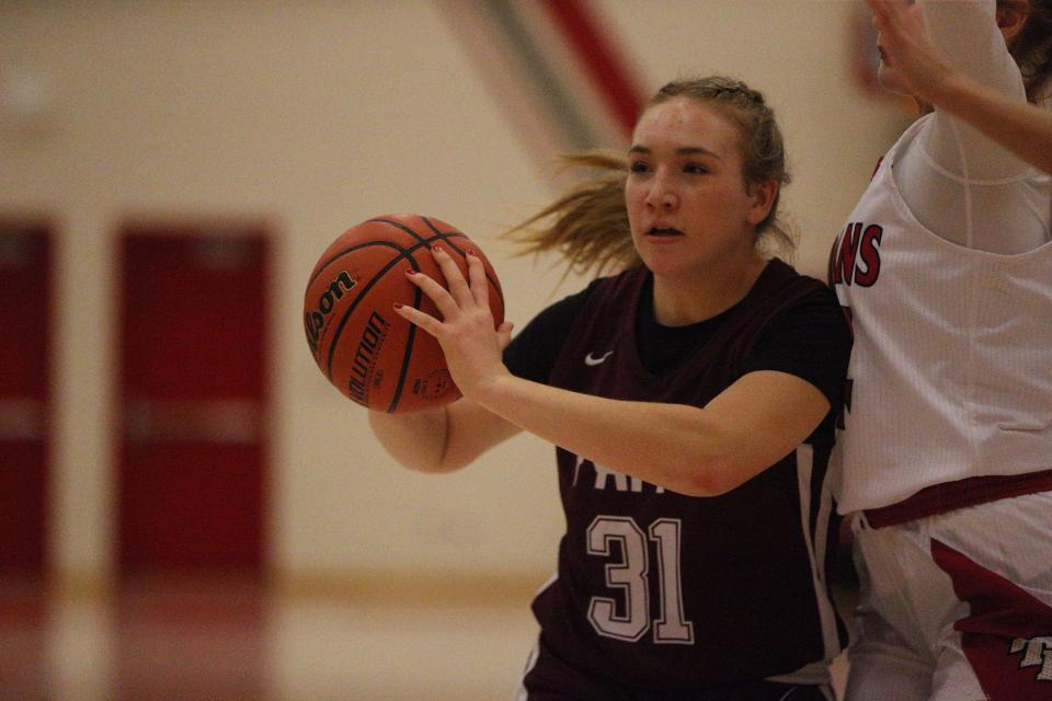 Faith Christian freshman Johanna Haste attempts to pass off defensive pressure by Twin Lakes during the Twin Lakes Holiday Tournament on Wednesday, Dec. 27, 2023.