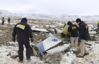 This photo provided by The National Transportation Safety Board shows NTSB investigators on Sunday, Feb. 26, 2023, at the crash site in Dayton, Nev., documenting the wreckage of a Pilatus PC-12 airplane a medical air transport flight operated by Guardian Flight that crashed on Friday, Feb. 24, while enroute from Reno, Nevada, to Salt Lake City. (NTSB via AP)