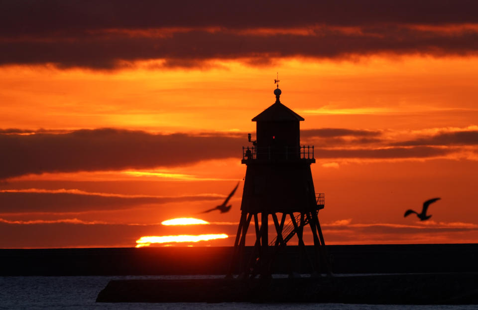 <p>Sunrise at the Herd Groyne lighthouse in South Shields on the North East coast on the Autumn Equinox. Picture date: Wednesday September 22, 2021, 2021.</p>
