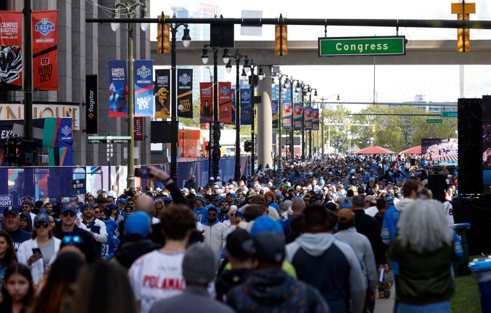 Thousands of NFL fans move along Woodward Avenue and near Campus Martius and the NFL draft theater area hours before the start of the draft in Detroit on Thursday, April 25, 2024.