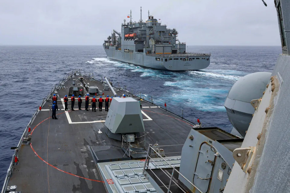 In this photo released by the US Navy The Arleigh Burke-class guided-missile destroyer USS John Finn (DDG 113) prepares to come alongside Lewis and Clark-class dry cargo ship Cesar Chavez (T-AKE-14) in the East China Sea, on Jan. 21, 2024.