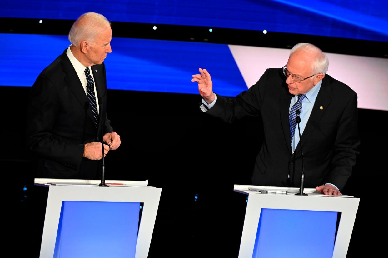 Joe Biden, left, and Bernie Sanders clash in the Democratic debate at Drake University in Des Moines, Iowa: AFP via Getty Images