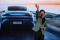 Xiaomi founder Lei Jun, waves after introducing the SU7, a sporty four-door sedan in Beijing, Thursday, March 28, 2024. Xiaomi, a well-known maker of smart consumer electronics in China, is joining the country's booming but crowded market for electric cars. (AP Photo/Ng Han Guan)