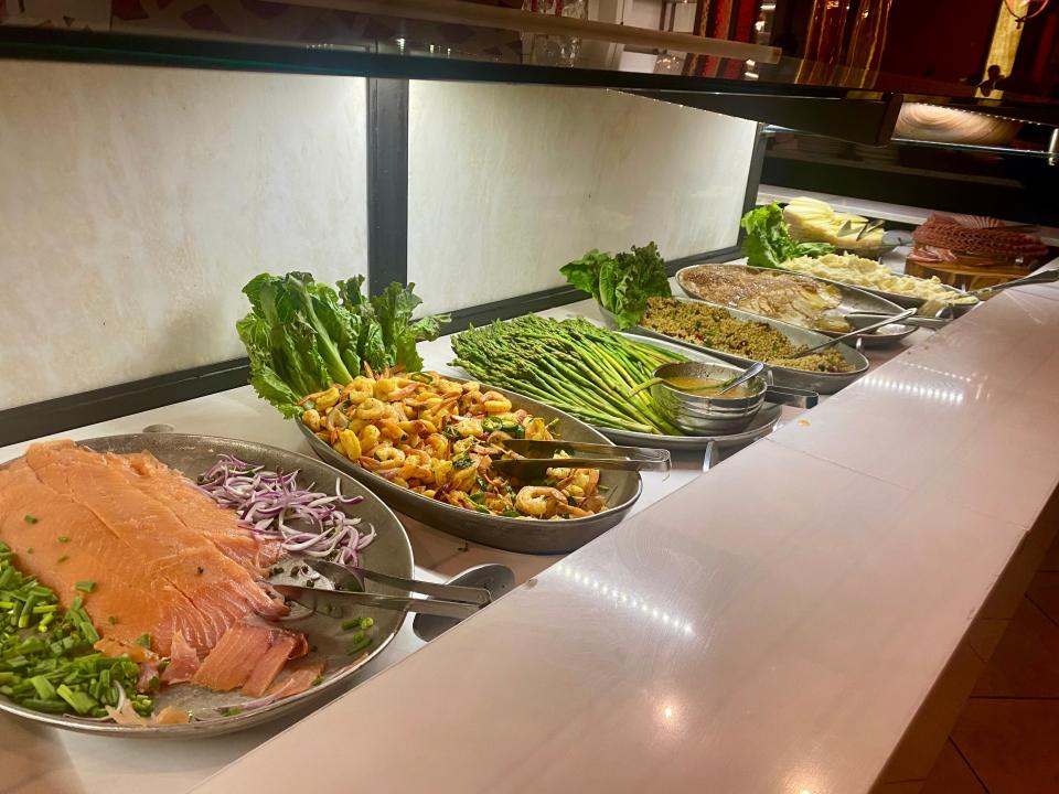 plates of salmon and veggies at the salad bar at texas de brazil steak house