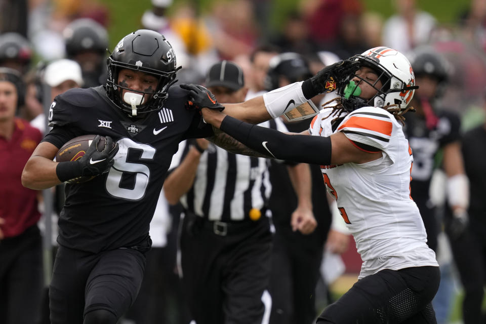 Iowa State running back Eli Sanders (6) tries to break a tackle by Oklahoma State cornerback Korie Black during the first half of an NCAA college football game, Saturday, Sept. 23, 2023, in Ames, Iowa. (AP Photo/Charlie Neibergall)