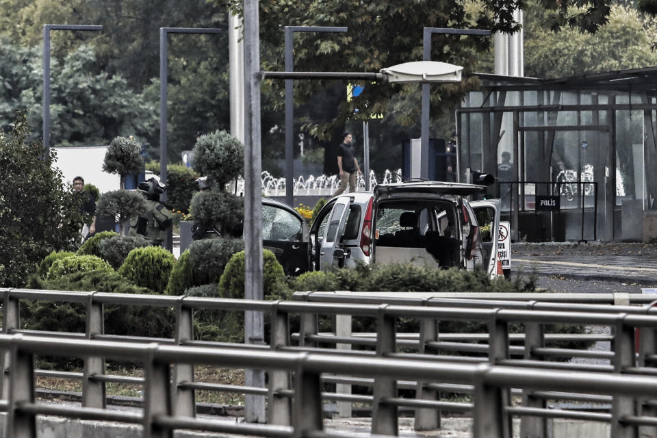 Turkish policemen and security forces cordon off an area next to a car after an explosion in Ankara, Sunday, Oct. 1, 2023. A suicide bomber detonated an explosive device in the heart of the Turkish capital, Ankara, on Sunday, hours before parliament was scheduled to reopen after a summer recess. A second assailant was killed in a shootout with police. (Yavuz Ozden/Dia Images via AP)