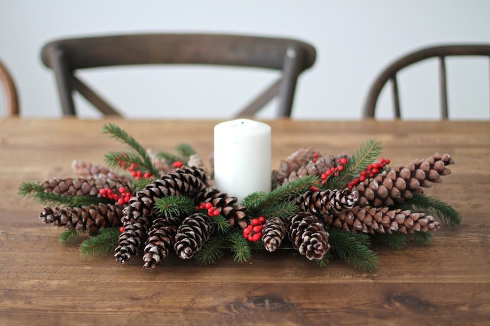 If you’re low on time simply go outside and collection some pinecones, berries and some greenery to place around a candle.