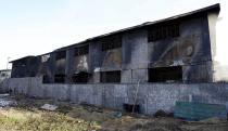 A a gutted slipper factory is pictured in Valenzuela, Metro Manila in the Philippines May 14, 2015.A fire at a factory making rubber slippers killed 31 workers in the Philippine capital on Wednesday, and dozens were missing and feared dead, officials said. REUTERS/Erik De Castro