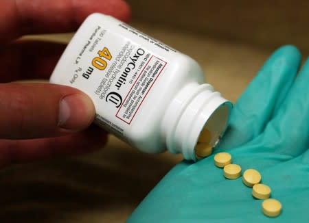 FILE PHOTO: A pharmacist holds prescription painkiller OxyContin at a local pharmacy