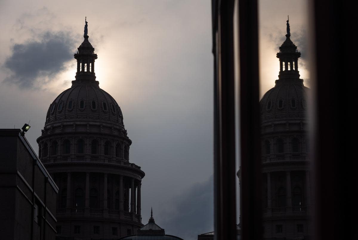 The sun sets behind the Texas Capitol in Austin on May 12, 2023.