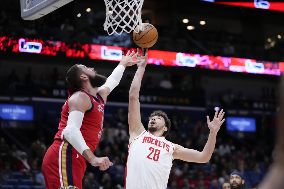 Houston Rockets center Alperen Sengun (28) shoots against New Orleans Pelicans center Jonas Valanciunas in the first half of an NBA basketball game in New Orleans, Saturday, Dec. 23, 2023. (AP Photo/Gerald Herbert)