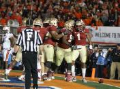 Jan 6, 2014; Pasadena, CA, USA; Florida State Seminoles wide receiver Kelvin Benjamin (1) celebrates his winning touchdown catch with teammates against the Auburn Tigers during the second half of the 2014 BCS National Championship game at the Rose Bowl. Mandatory Credit: Matthew Emmons-USA TODAY Sports