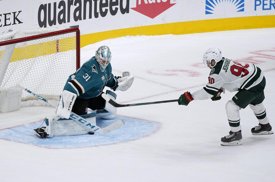 San Jose Sharks goaltender Martin Jones (31) blocks a shot by Minnesota Wild center Marcus Johansson (90) during a shootout in an NHL hockey game in San Jose, Calif., Monday, March 29, 2021. San Jose won 3-2 in the shootout. (AP Photo/Tony Avelar)