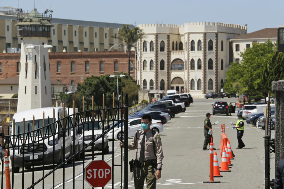 FILE - In this July 9, 2020, file photo, a correctional officer closes the main gate at San Quentin State Prison in San Quentin, Calif. Prison guards are refusing coronavirus vaccines at alarming rates. That's causing some public health experts to worry about the prospect of controlling the pandemic both inside and outside of prison. (AP Photo/Eric Risberg, File)