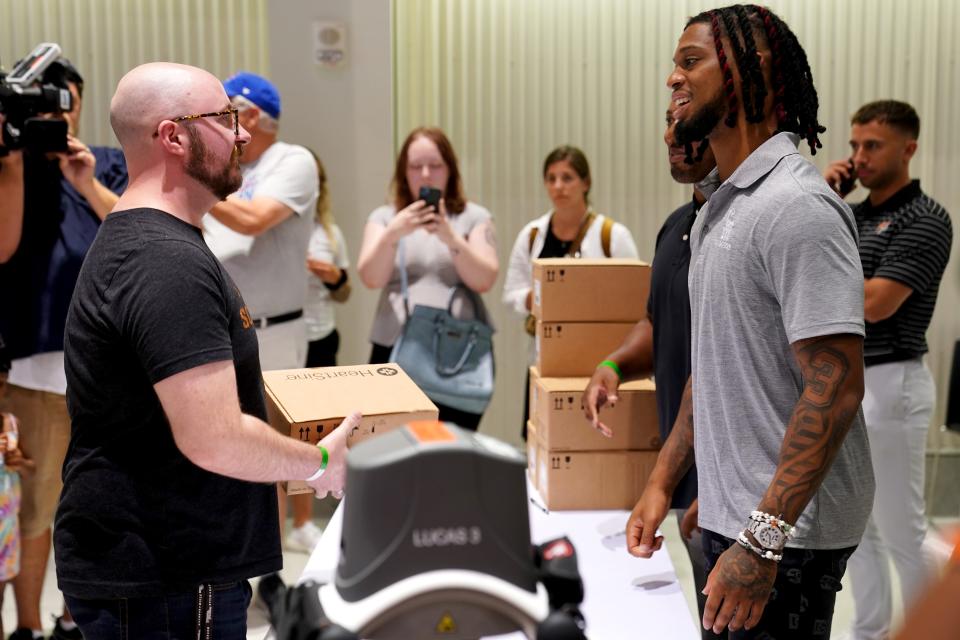 Buffalo Bills safety Damar Hamlin greets attendees and distributes automated external defibrillators following a hands-only CPR training event as part of the Chasing M’s
Foundation CPR tour, Saturday, July 22, 2023, at Tangeman University Center on the campus of the University of Cincinnati in Cincinnati.