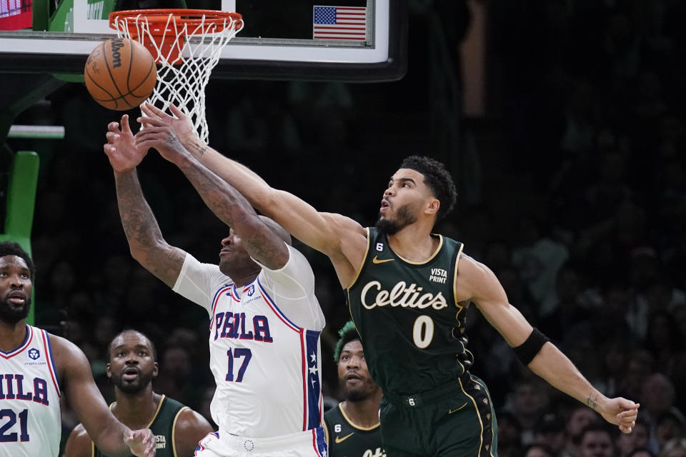 Boston Celtics forward Jayson Tatum (0) knocks the ball away on a pass to Philadelphia 76ers forward P.J. Tucker (17) during the first half of an NBA basketball game Tuesday, Oct. 18, 2022, in Boston. (AP Photo/Charles Krupa)